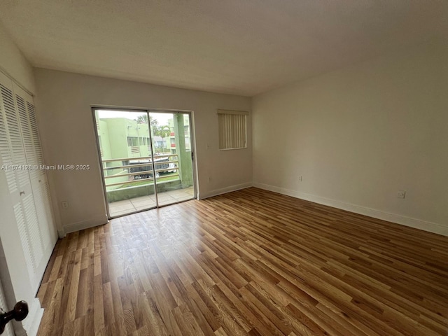 unfurnished room featuring hardwood / wood-style flooring