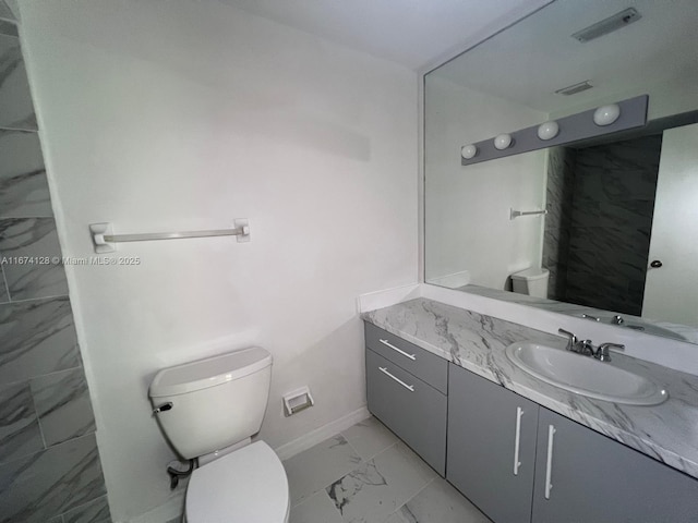 bathroom with toilet and vanity