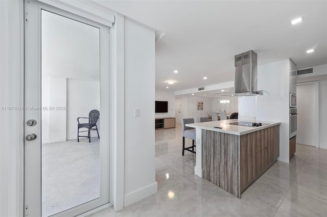 2751 S Ocean Dr Unit 1802S, Hollywood, FL 33019 - kitchen featuring a breakfast bar area, black electric cooktop, stainless steel oven, and range hood