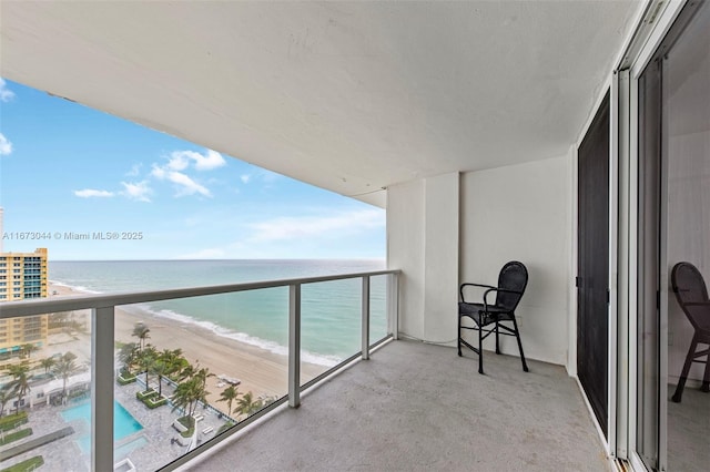 balcony with a water view and a beach view