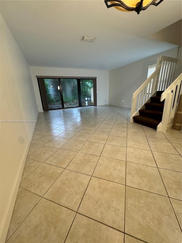 tiled spare room with a healthy amount of sunlight