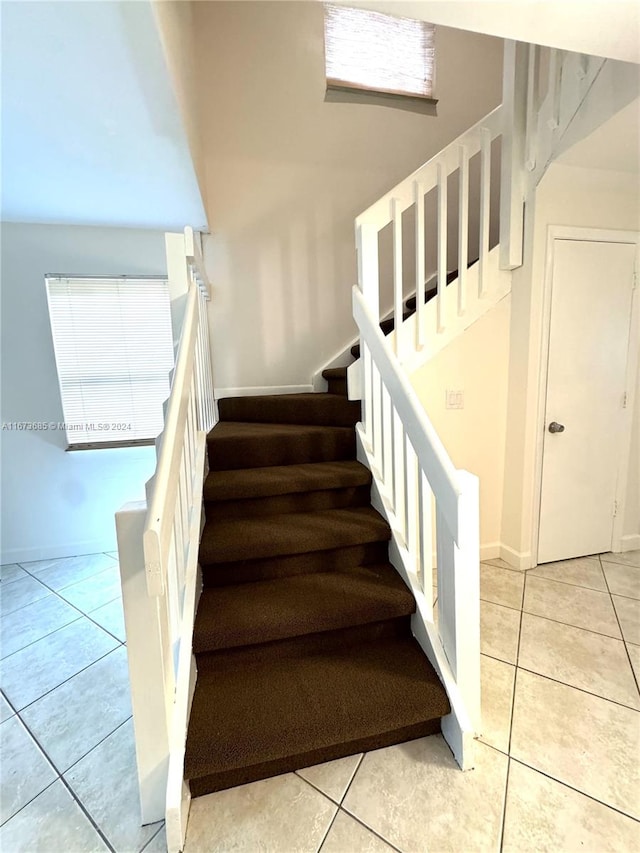 staircase featuring tile patterned floors