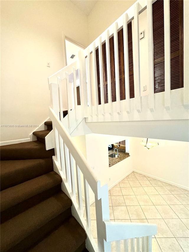 stairs featuring tile patterned flooring