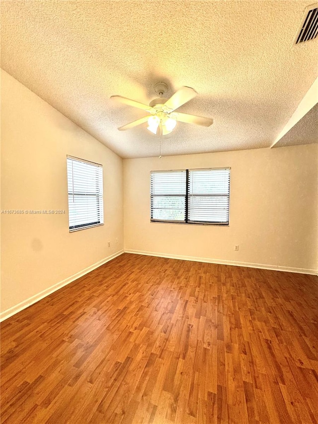 spare room featuring ceiling fan, a textured ceiling, and hardwood / wood-style flooring