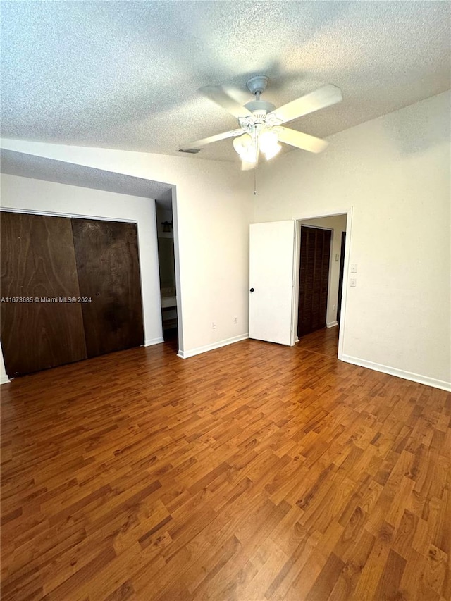 unfurnished bedroom with wood-type flooring, a textured ceiling, and ceiling fan