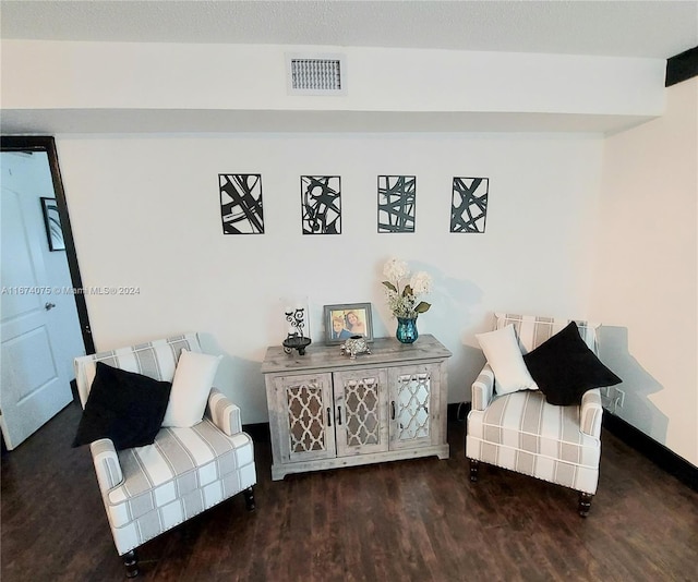 sitting room featuring dark wood-type flooring