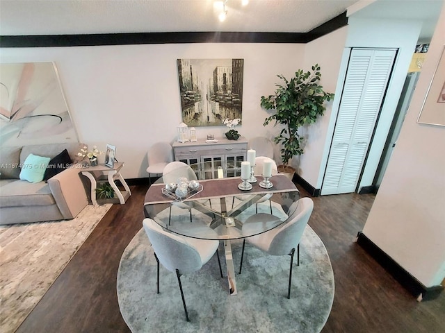 dining area featuring crown molding and dark hardwood / wood-style flooring