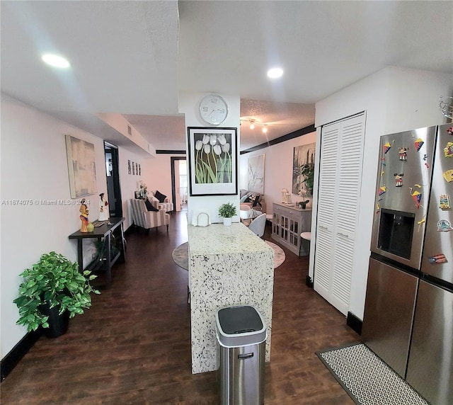 kitchen featuring dark hardwood / wood-style flooring and stainless steel refrigerator with ice dispenser