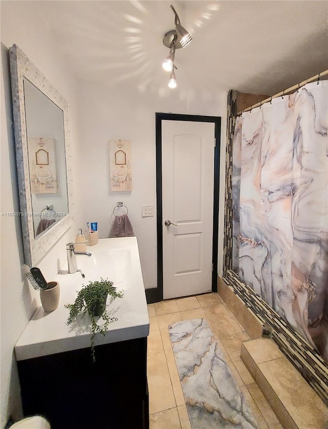 bathroom featuring tile patterned floors, vanity, and a shower with shower curtain