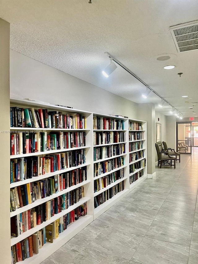 interior space featuring a textured ceiling and track lighting