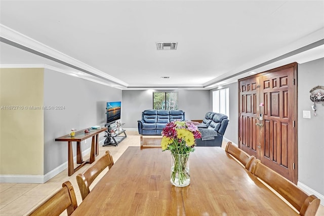 dining space with ornamental molding and light wood-type flooring