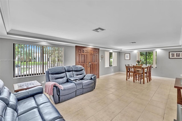 living room with light tile patterned flooring and ornamental molding