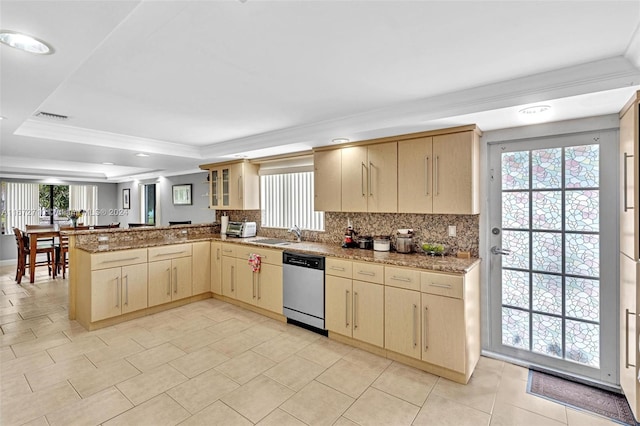 kitchen with kitchen peninsula, a healthy amount of sunlight, stainless steel dishwasher, and light brown cabinets