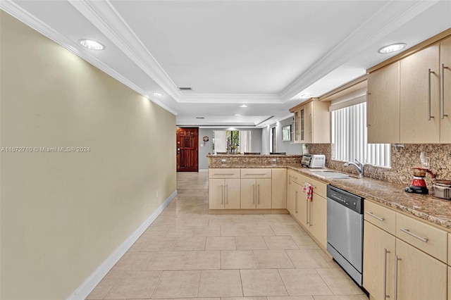 kitchen with a raised ceiling, kitchen peninsula, stainless steel dishwasher, light brown cabinetry, and crown molding