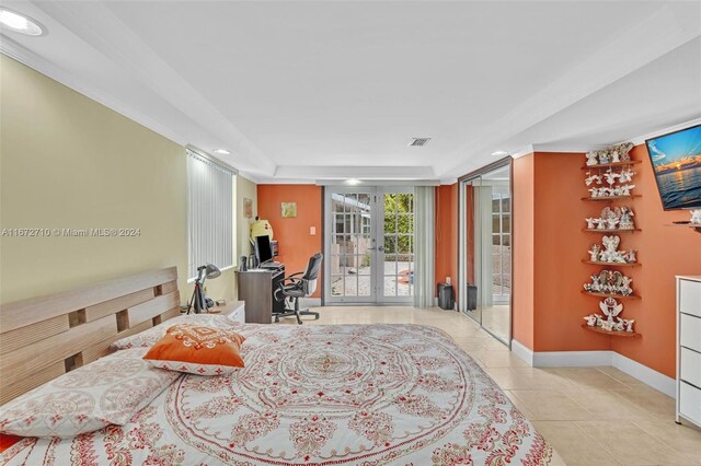 interior space featuring a raised ceiling and french doors