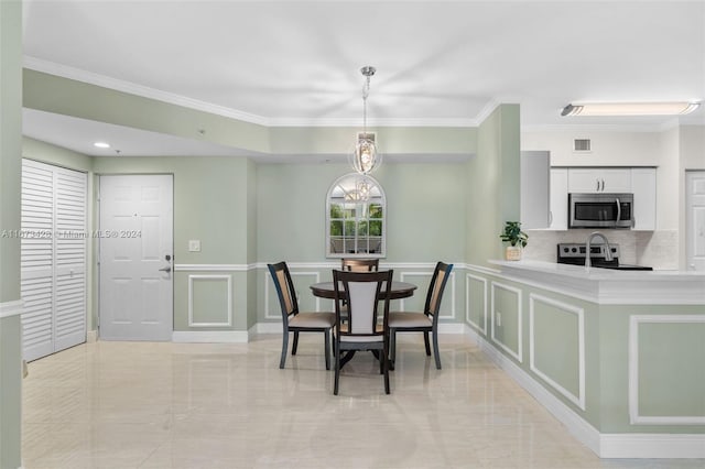 dining room featuring a chandelier and crown molding