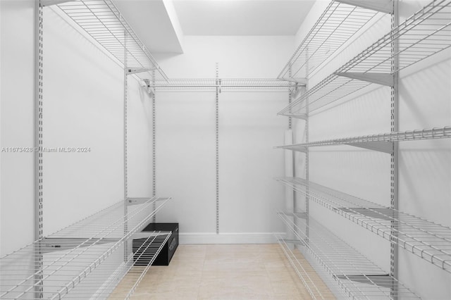 spacious closet featuring light tile patterned floors