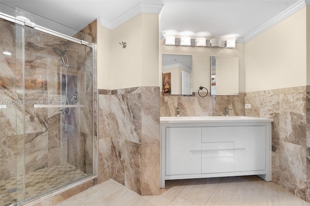 bathroom with crown molding, a shower with door, and tile walls