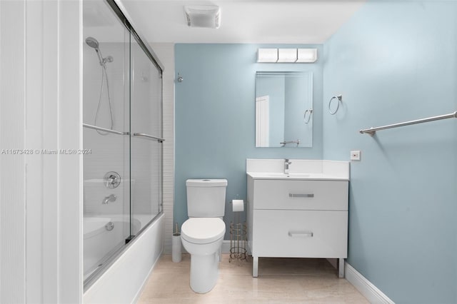 full bathroom featuring toilet, combined bath / shower with glass door, and vanity