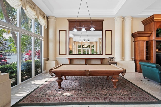 recreation room featuring billiards, a raised ceiling, ornate columns, and a wealth of natural light