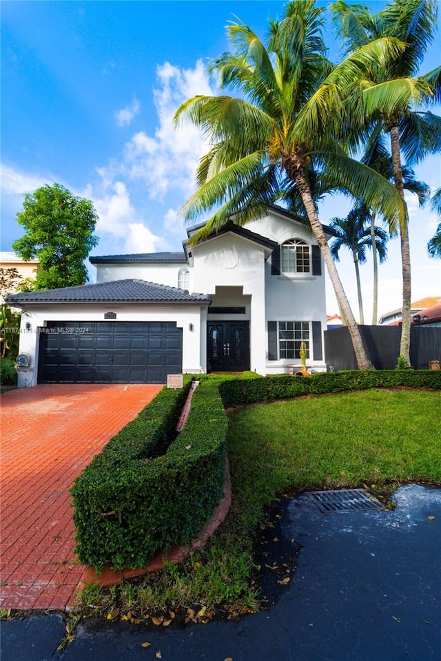 view of front of home featuring a garage and a front lawn