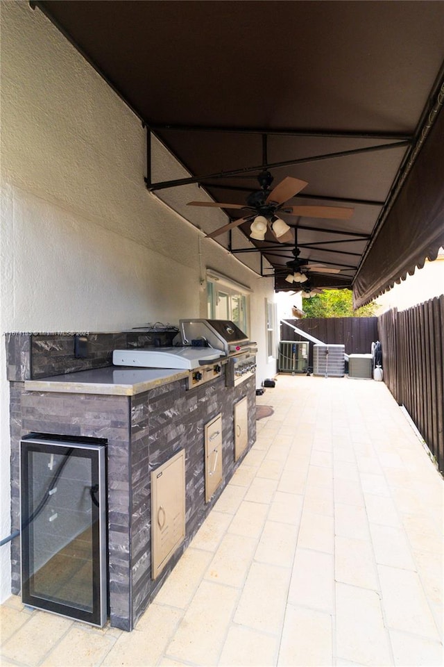 view of patio with area for grilling and ceiling fan