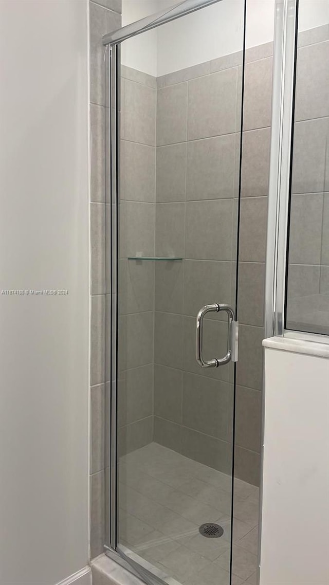 bathroom featuring a shower with shower door