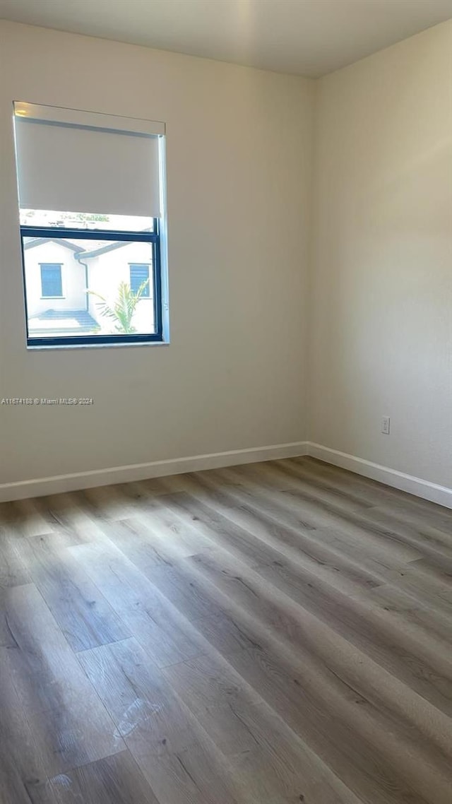 empty room with hardwood / wood-style flooring