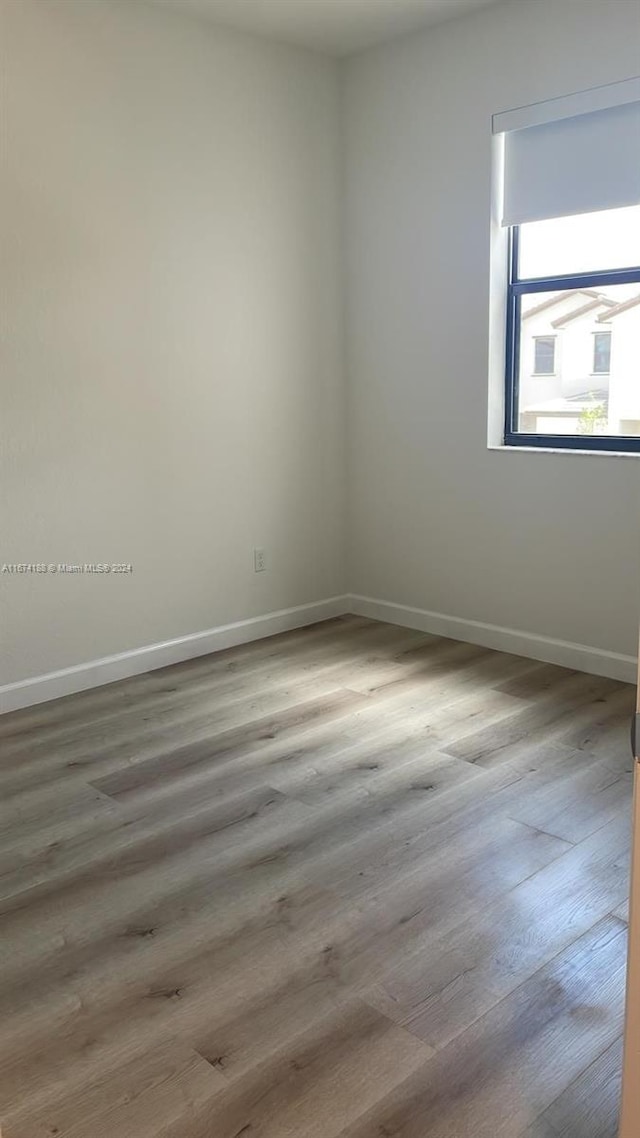 unfurnished room featuring hardwood / wood-style floors