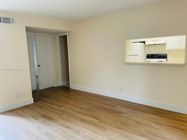 empty room with light hardwood / wood-style flooring