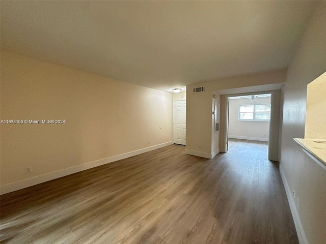 empty room featuring hardwood / wood-style flooring and ceiling fan