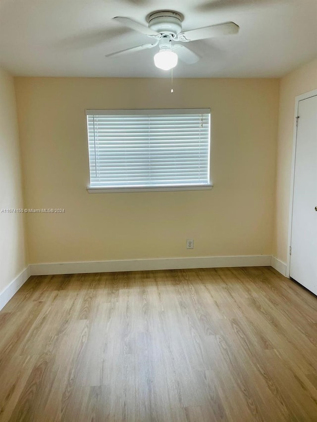 spare room featuring light hardwood / wood-style floors and ceiling fan