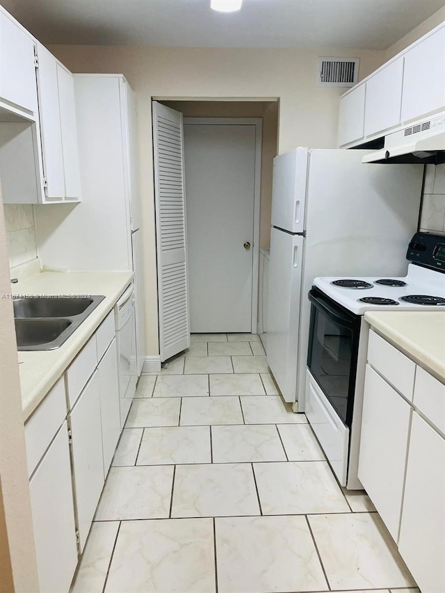 kitchen featuring white cabinetry, sink, and white appliances