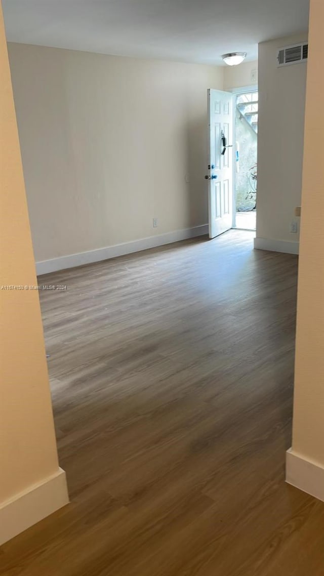 empty room with hardwood / wood-style flooring