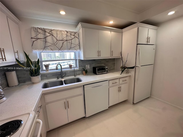 kitchen featuring tasteful backsplash, white appliances, sink, and white cabinets