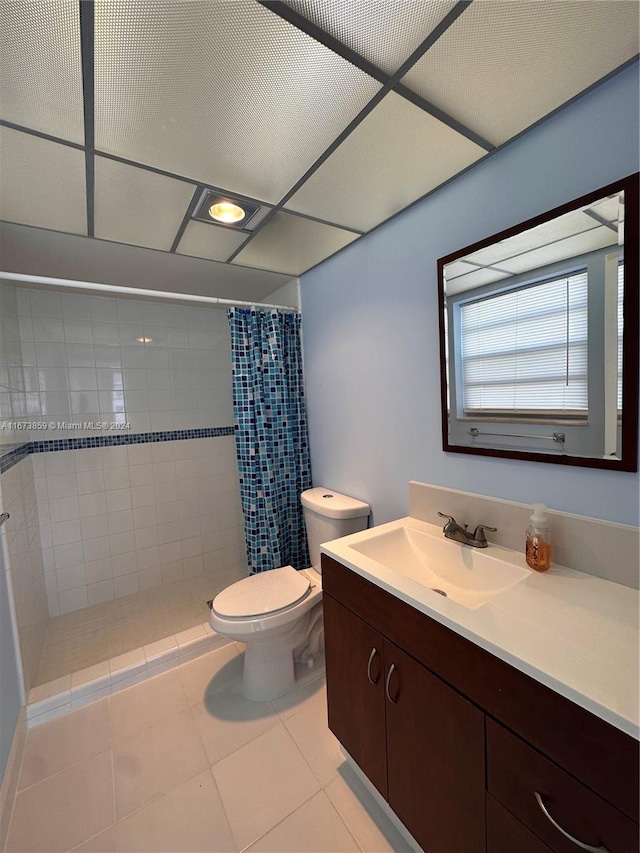 bathroom with curtained shower, tile patterned floors, vanity, and toilet