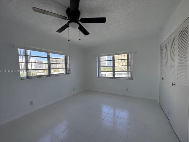 3181 S Ocean Dr Unit 501, Hallandale Beach, FL 33009 - unfurnished bedroom with a closet, baseboards, a textured ceiling, and ceiling fan