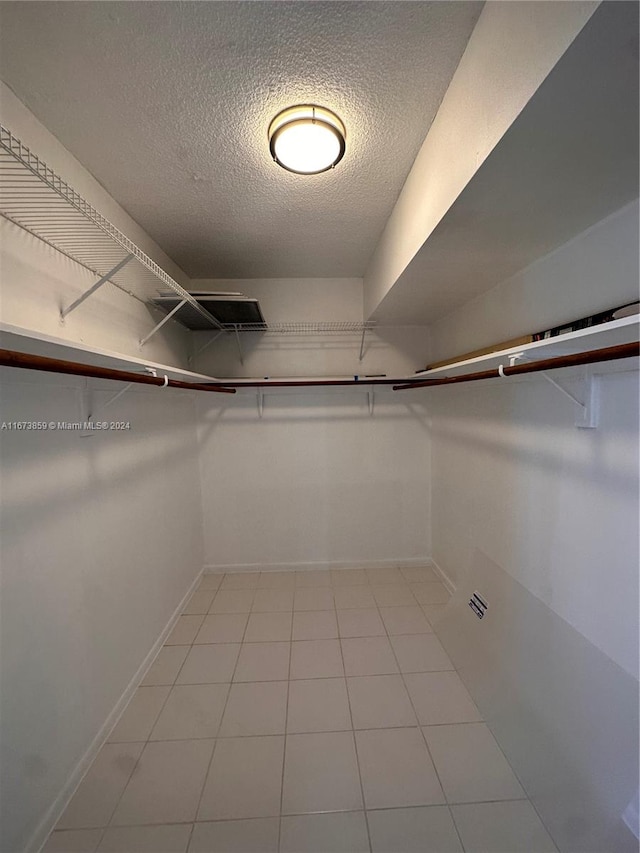 spacious closet with light tile patterned floors