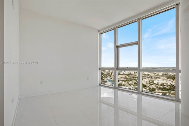 unfurnished room with plenty of natural light and tile patterned flooring