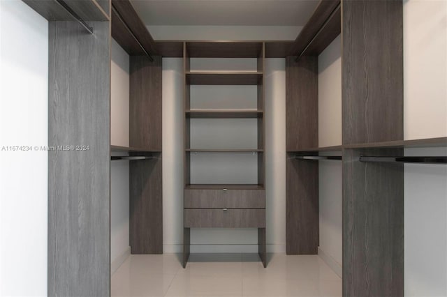 spacious closet featuring light tile patterned floors