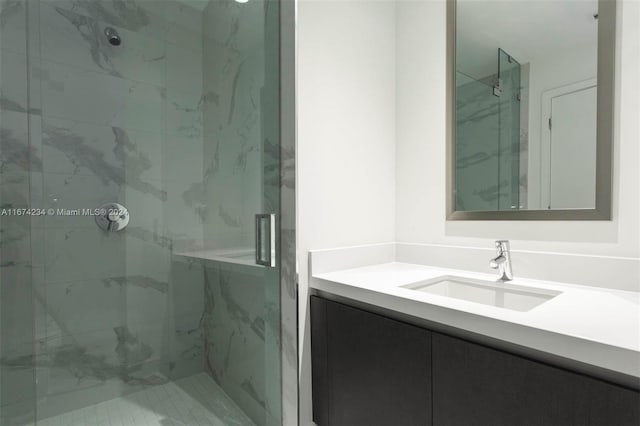 bathroom featuring vanity and an enclosed shower