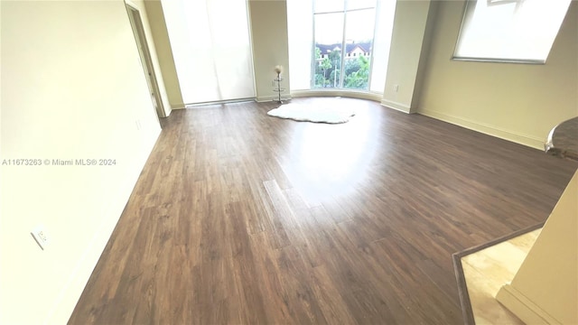 spare room with dark hardwood / wood-style floors