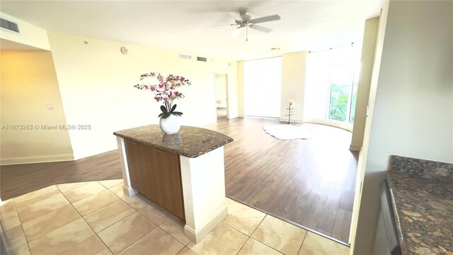 510 NW 84th Ave Unit 529, Plantation, FL 33324 - kitchen with a ceiling fan, dark stone countertops, light tile patterned floors, and a kitchen island
