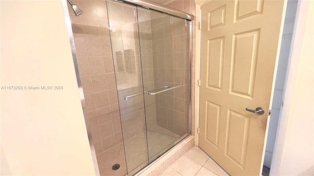 bathroom with tile patterned flooring and an enclosed shower