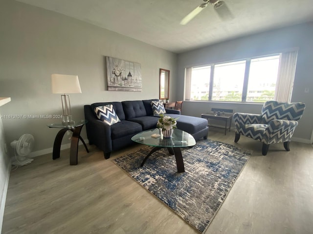 living room with wood-type flooring and ceiling fan