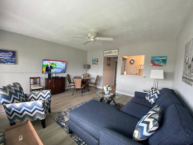 living room featuring ceiling fan and hardwood / wood-style floors