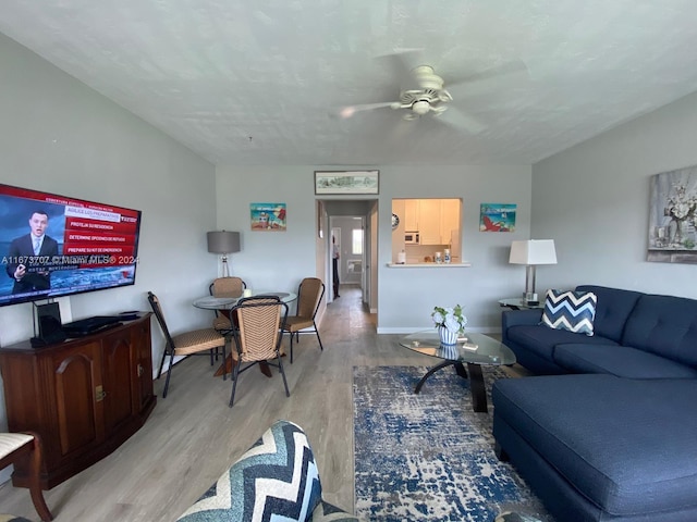 living room featuring ceiling fan and light wood-type flooring