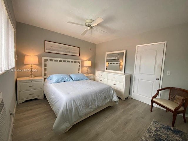 bedroom with light wood-type flooring and ceiling fan