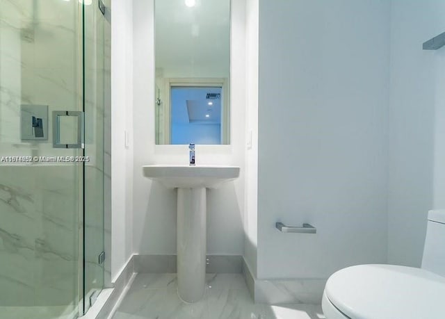 bathroom featuring an enclosed shower and toilet