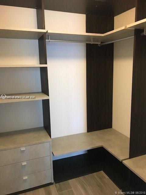 walk in closet featuring light hardwood / wood-style flooring